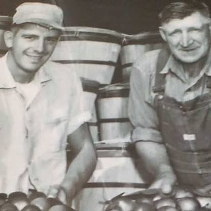 Founder Jake Hagen and his son Kenny Hagen at the orchard, vintage black and white photo