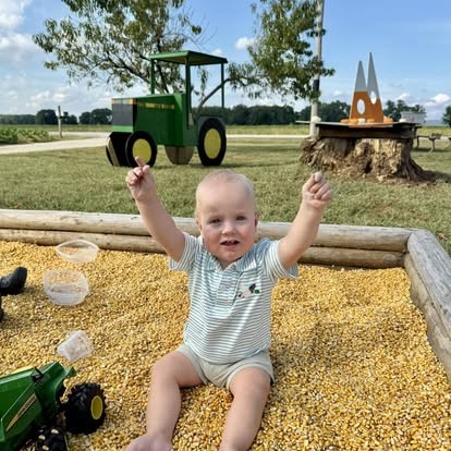 A kid enjoying the corn pit