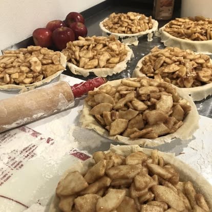 Several apple pies ready to go in the oven